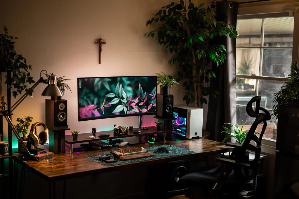 desk setup with plants and wood desk